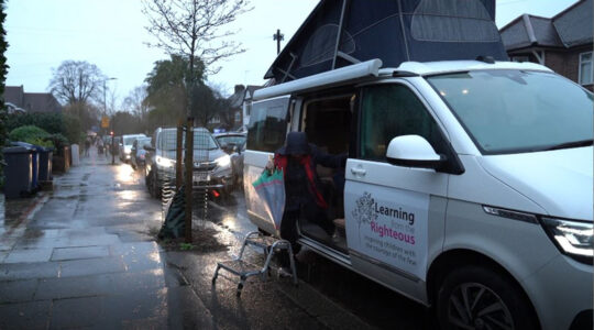 Holocaust survivor Mala Tribich exits the Learning from the Righteous mobile studio in London, UK in December 2020. (Learning from the Righteous)