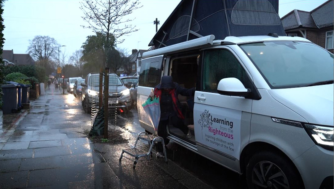 Holocaust survivor Mala Tribich exits the Learning from the Righteous mobile studio in London, UK in December 2020. (Learning from the Righteous)