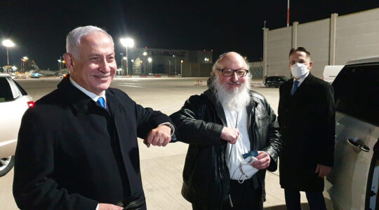 Jonathan Pollard, right, bumps elbows with Benjamin Netanyahu at Ben Gurion Airport, Israel on Dec. 30, 2020. (GPO)