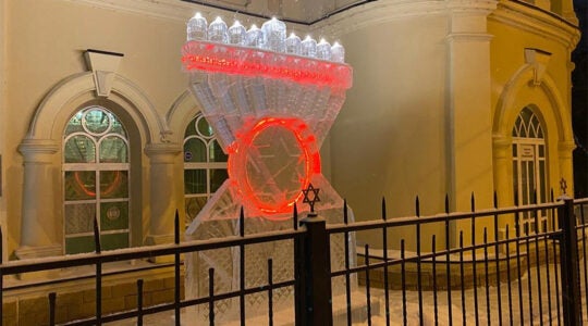 Snow falls on a Hanukkah Menorah made of ice in Tomsk, Russia on Dec. 8, 2020. (Levy Kaminetsky)