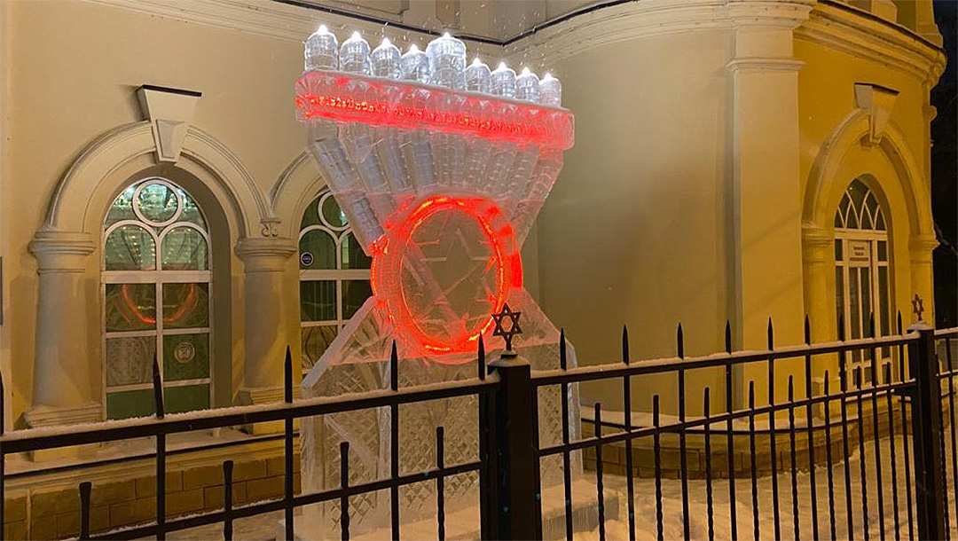 Snow falls on a Hanukkah Menorah made of ice in Tomsk, Russia on Dec. 8, 2020. (Levy Kaminetsky)