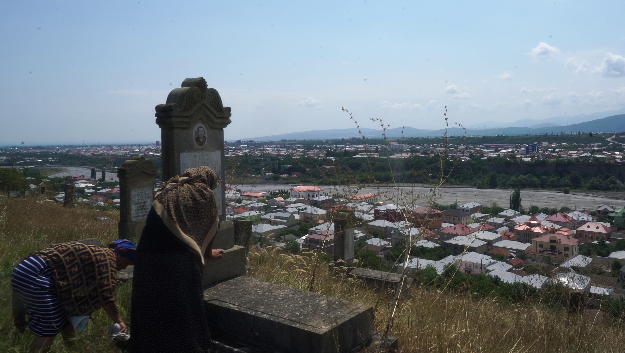 Women mourn their relatives at the cemetery overlooking the Jewish town of Krasnaiya Sloboda in northern Azerbaijan on July 21, 2018. (Cnaan Liphshiz)