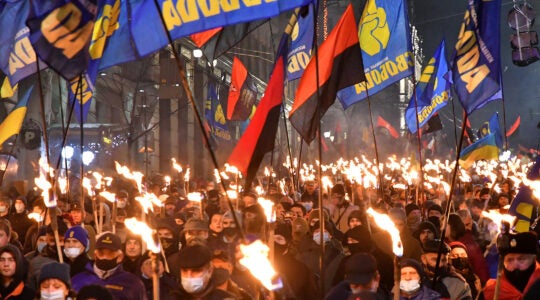 Participants of an annual event in honor of Stepan Bandera march through Kyiv, Ukraine on Jan. 1, 2021. (Genya Savilou/AFP via Getty Images)