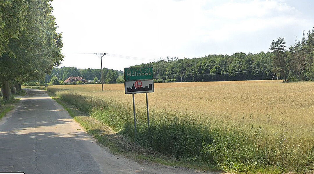 A sign at the entrance to the village of Malinowo, Poland. (Google Maps)