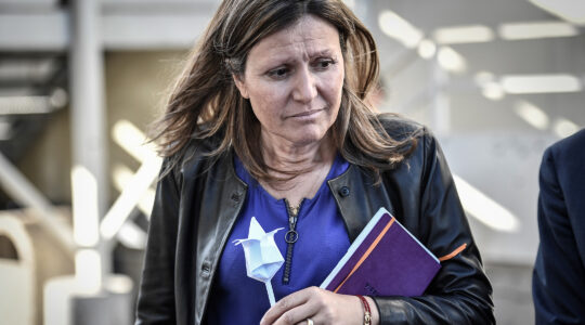 French-Jewish lawmaker Yael Braun-Pivet holds a paper flower offered by a man at a migrant detention center in Paris, France on Sept. 18, 2019. (Stephane de Sakutin/AFP via Getty Images)