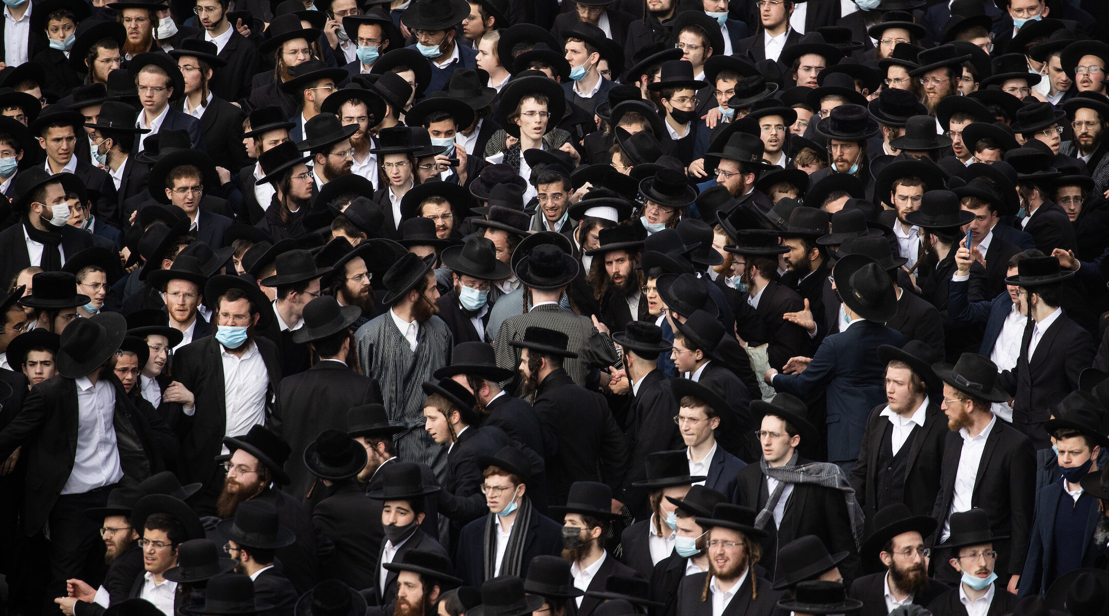 Thousands of haredi Orthodox men crowded the streets of Jerusalem on Sunday for a funeral, the latest in a seies of high-profile violations of COVID restrictions in Israel's haredi sector. (Yonatan Sindel/Flash90)