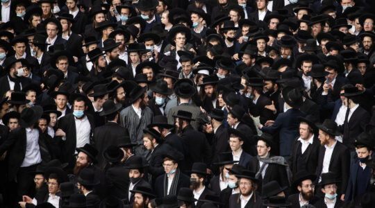 Thousands of haredi Orthodox men crowded the streets of Jerusalem on Sunday for a funeral, the latest in a seies of high-profile violations of COVID restrictions in Israel's haredi sector. (Yonatan Sindel/Flash90)
