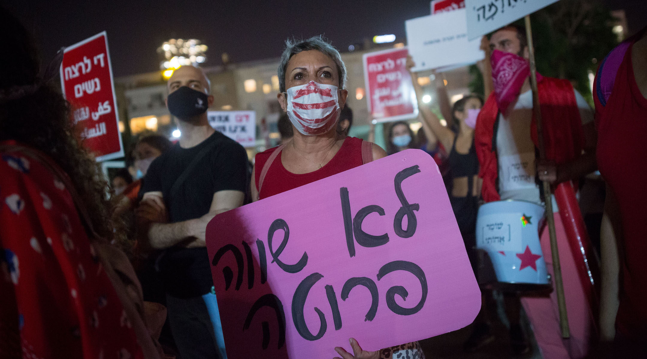 Activists protest violence against women at Habima square in Tel Aviv on October 21, 2020. (Miriam Alster/Flash90)