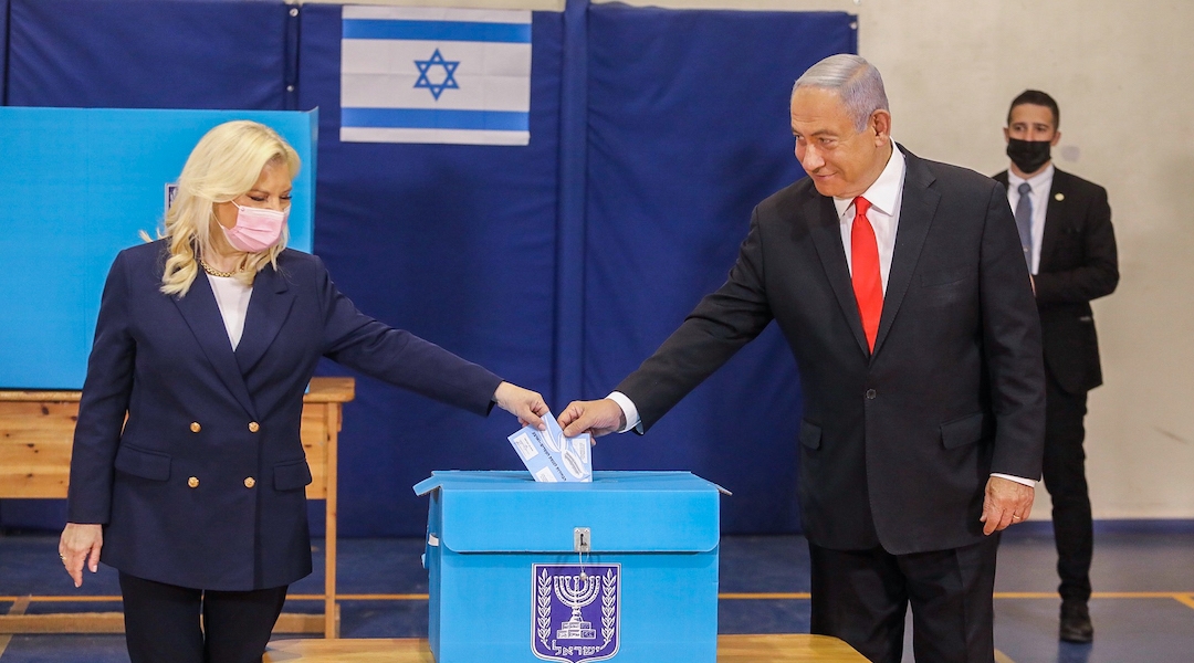 Israeli Prime Minister Benjamin Netanyahu and his wife, Sara, vote in Jerusalem on March 23, 2021. (Marc Israel Sellem/Flash90)