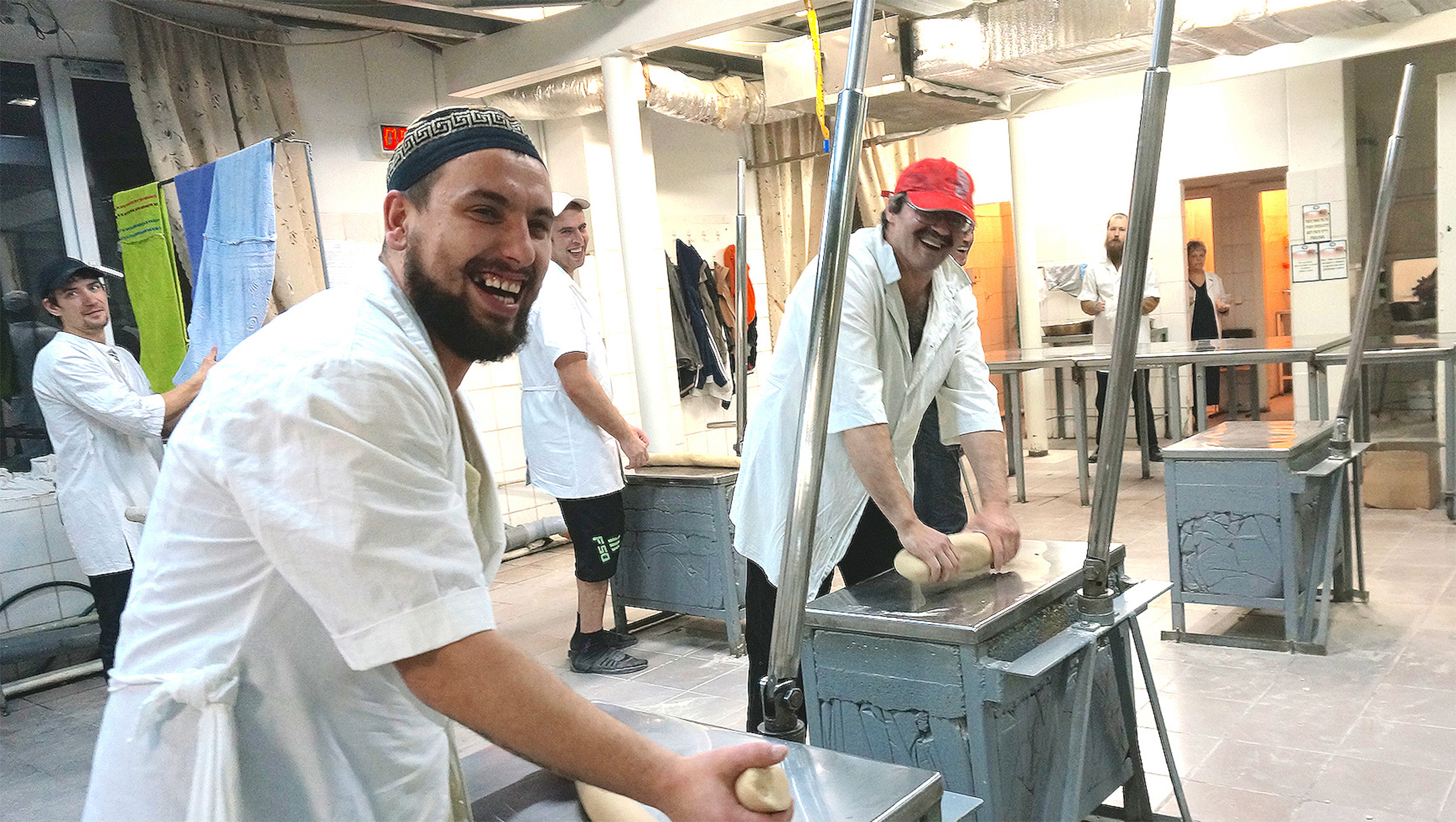 Workers knead dough at the Tiferet Matzot factory roll dough in Dnepro, Ukraine on Dec. 8, 2014. (Cnaan Liphshiz/JTA)