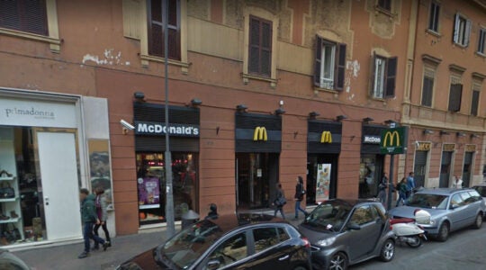 Pedestrians walk past the McDonnald's restaurant on Piazza Re di Roma in Rome, Italy in 2015. (Google)