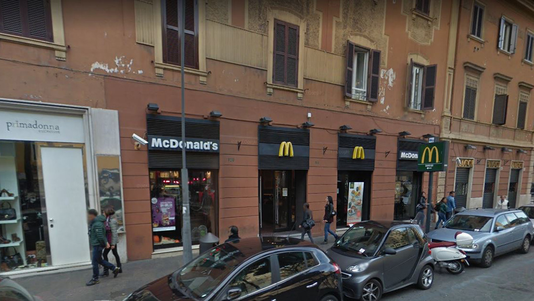 Pedestrians walk past the McDonnald's restaurant on Piazza Re di Roma in Rome, Italy in 2015. (Google)