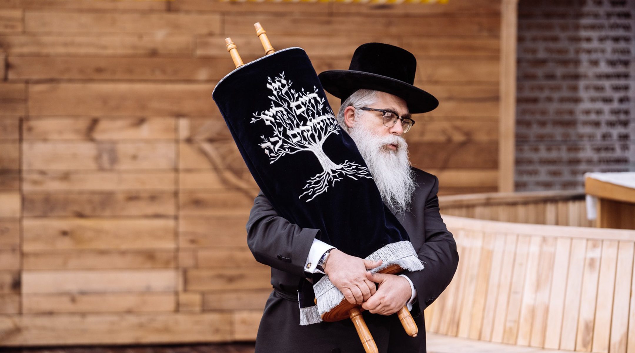 Ukrainian Chief Rabbi Ya’akov Dov Bleich holds a Torah scroll during the opening ceremony in Kyiv, Ukraine on April 7, 2021 of a synagogue on the site of the Babi Yar 1941 massacre of Jews. (Babyn Yar Holocaust Memorial Center)