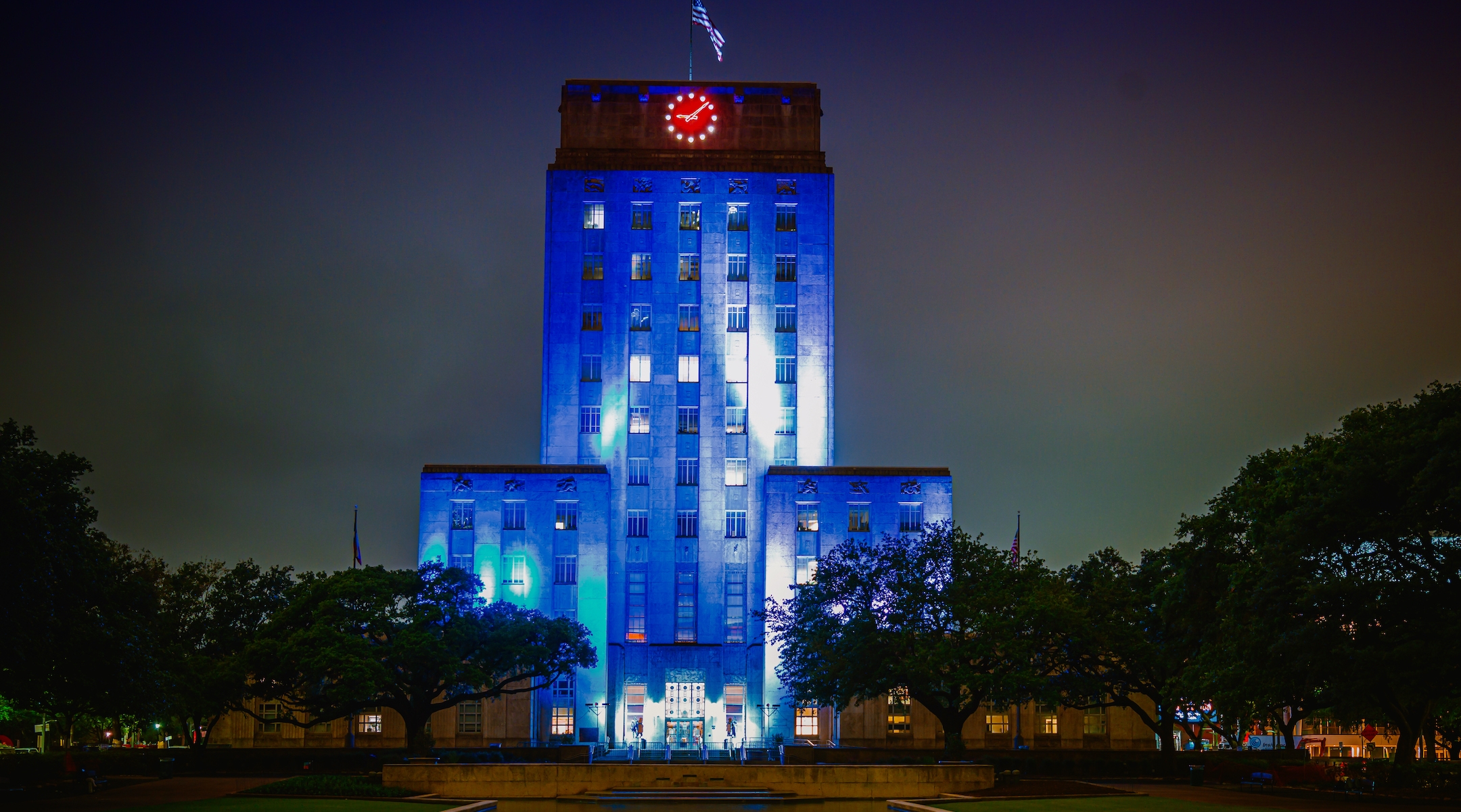 A City Hall lit up in blue and white