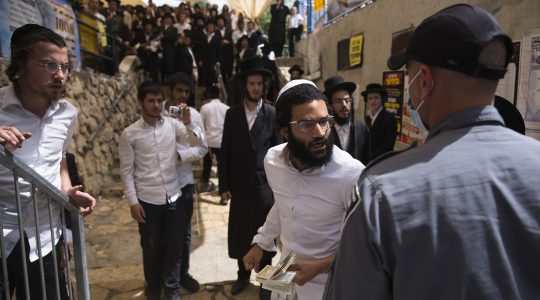Mourners gather during the funeral of one of those who died in a stampede during the Jewish religious festival of Lag Ba'Omer at the Jewish Orthodox pilgrimage site of Mount Meron in Israel on April 30, 2021. (Ilia Yefimovich/picture alliance via Getty Images)