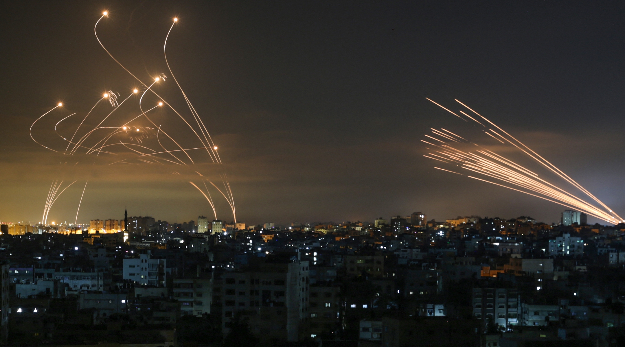 The Iron Dome interceptors (left) meet a volley of missiles from Gaza (right) on May 14, 2021. (Anas Baba/AFP via Getty Images)