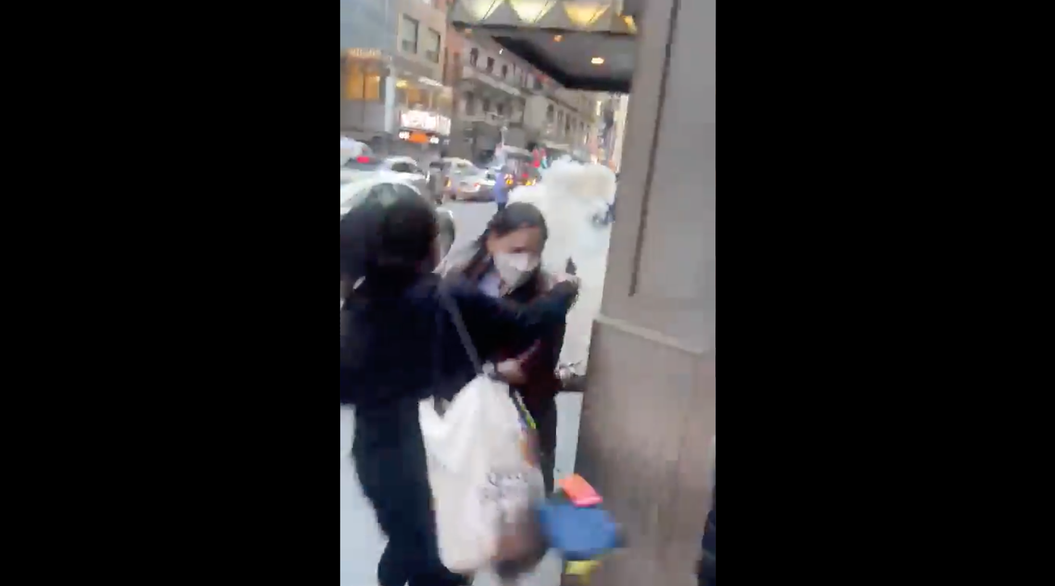 People dodge the smoke coming from two fireworks thrown from a car in midtown Manhattan amid an altercation involving pro-Palestinian protesters. (Screenshot)