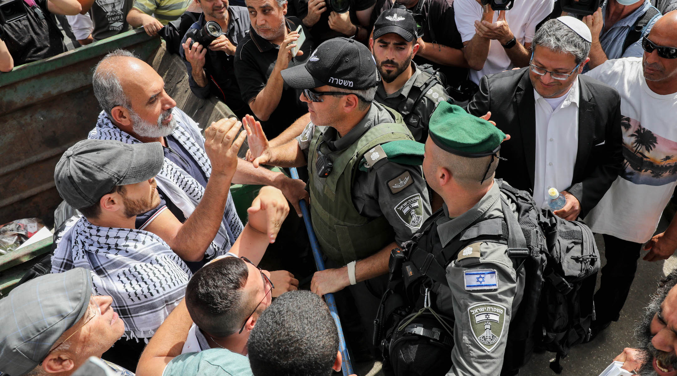 Israeli security forces clash with protesters during a protest against Israel's plan to evict Palestinians from the eastern Jerusalem neighborhood of Sheikh Jarrah on May 10, 2021. Itamar Ben-Gvir, a far-right Israeli lawmaker, is at right wearing a white kippah. (Olivier Fitoussi/Flash90)