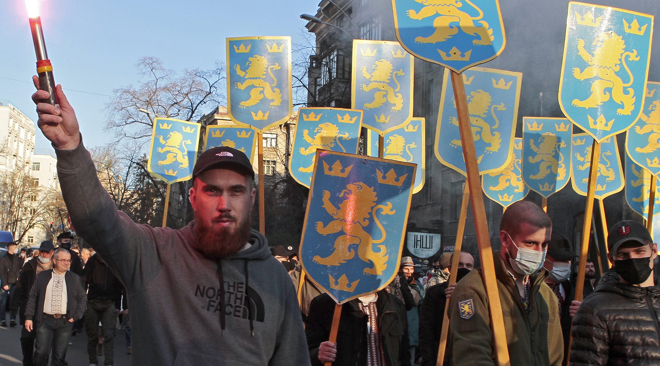 Marchers hold up the symbol of the 14th Waffen Grenadier Division of the SS in Kyiv, Ukraine on April 28, 2021. (Anna Marchenko\TASS via Getty Images)