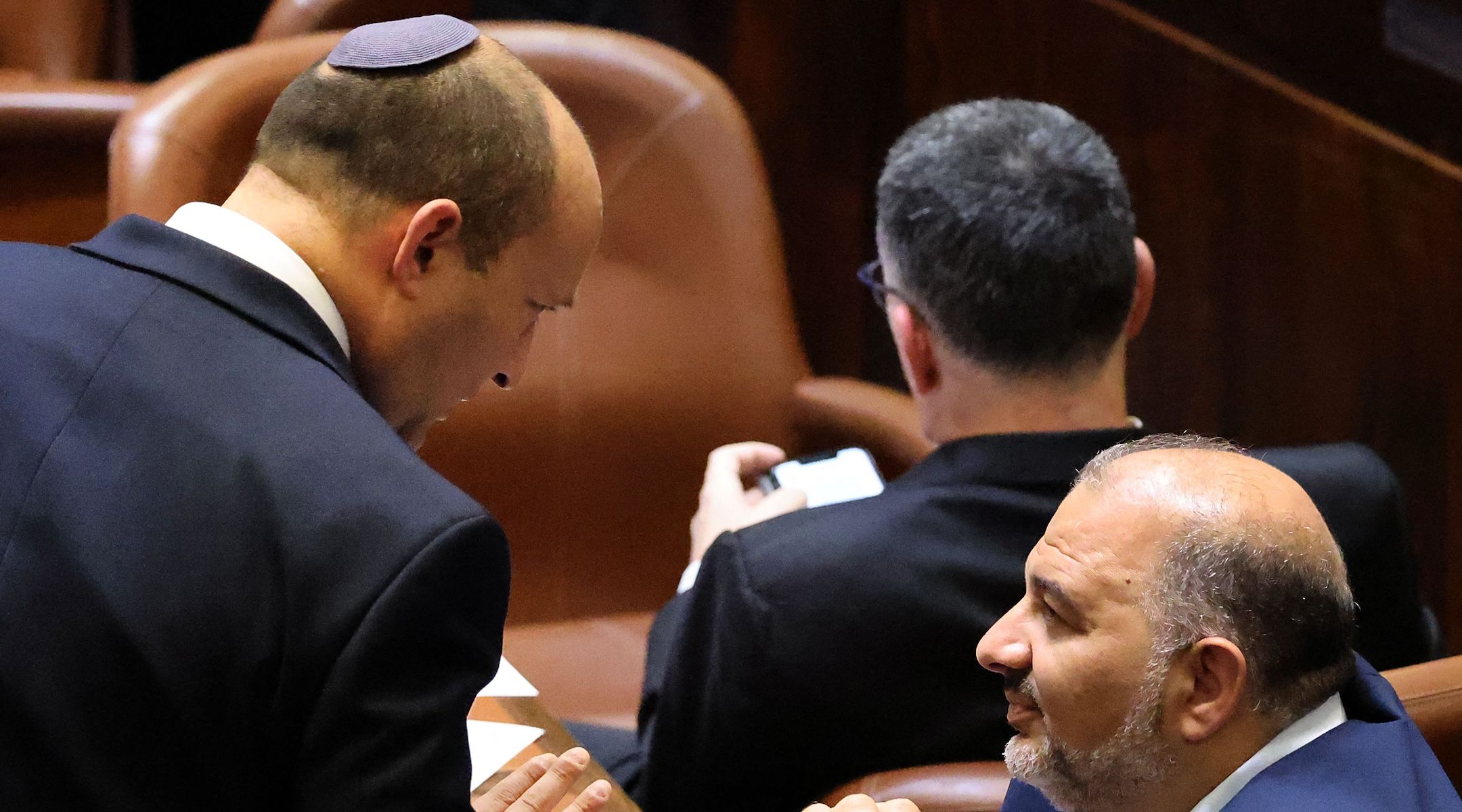 Naftali Bennett (left) speaks in Israel's Knesset with coalition partner Mansour Abbas on June 13, 2021, the day Bennett became prime minister of Israel. (Emmanuel Dunand/AFP via Getty Images)