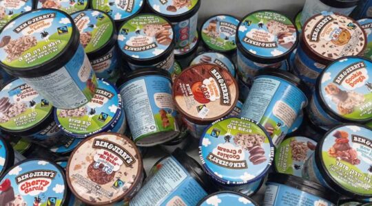 A freezer full of Ben & Jerry's ice cream with Hebrew lettering on the labels
