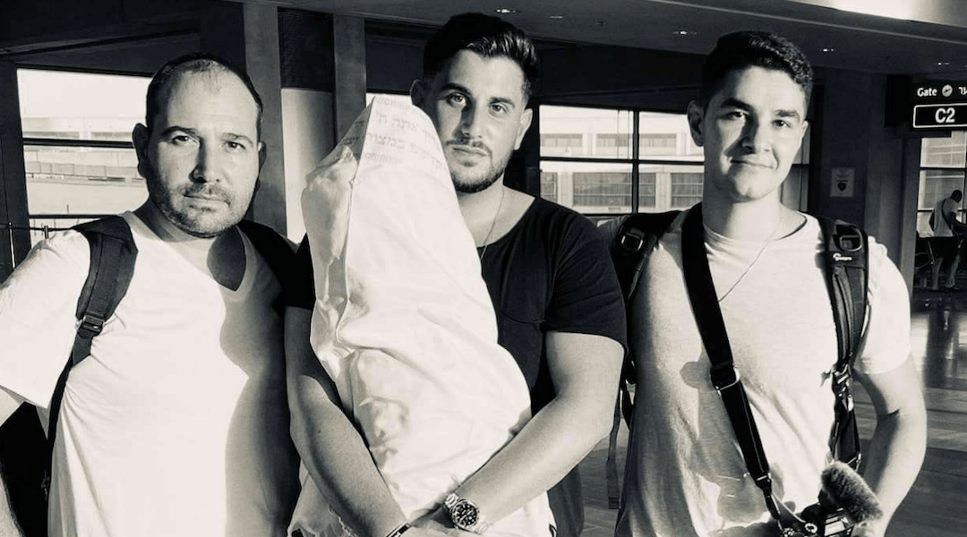 From left: Edouard David Benaym, Rudy Rochman and Andrew Leibman pose with the Torah scroll before their trip to Nigeria. (Courtesy of We Were Never Lost)