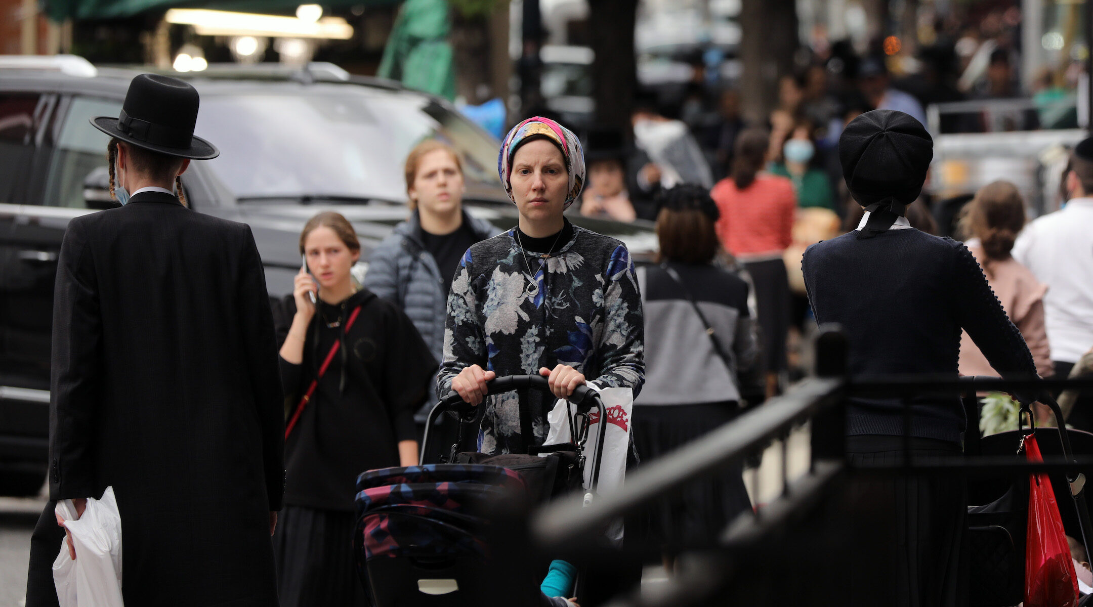 People walk through the Brooklyn neighborhood of Williamsburg in New York City