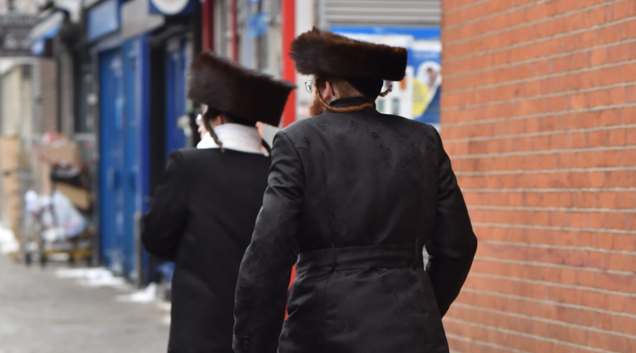Jewish men walk in Stamford Hill, London