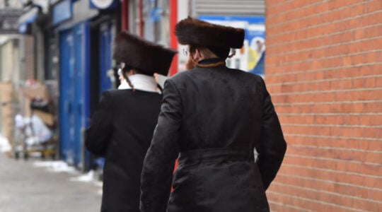 Jewish men walk in Stamford Hill, London