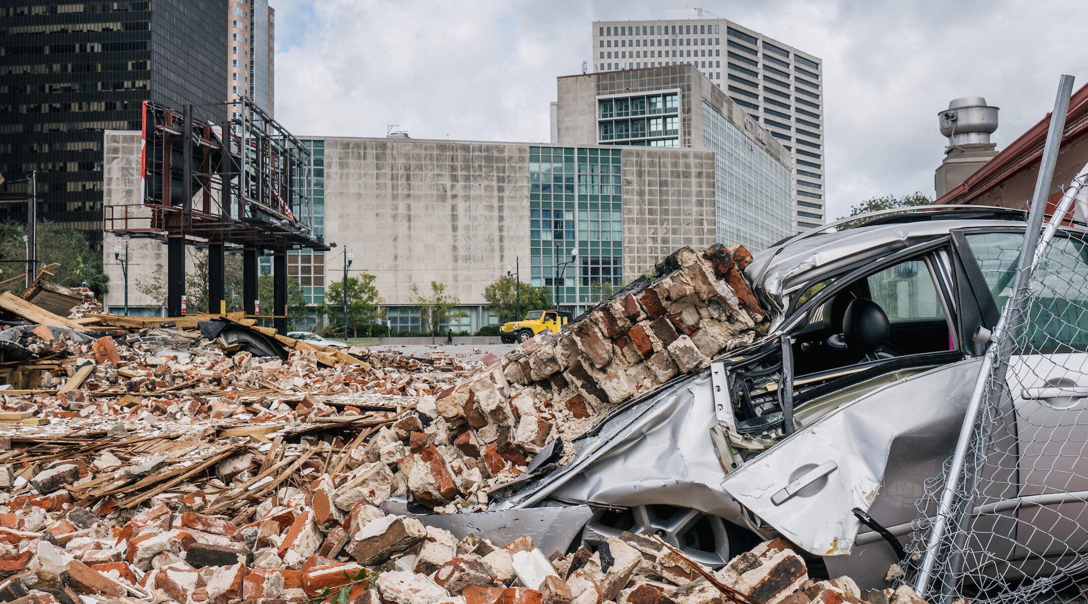 A car is seen under rubble