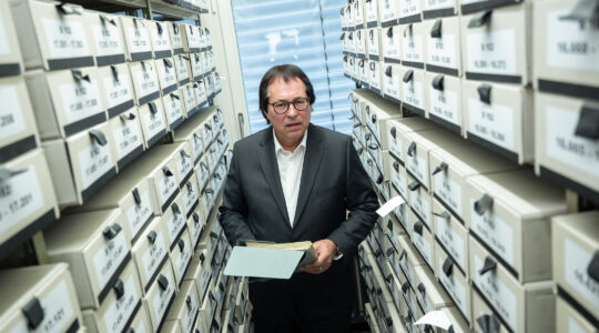 Thomas Will, head of the Central Office for the Investigation of National Socialist Crimes, stands among the office's files