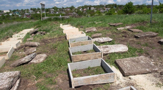 Renovation works at the Jewish cemetery in Sataniv, Ukraine in 2021. (Dmitry Polyukhovich/Jewish Heritage Europe)