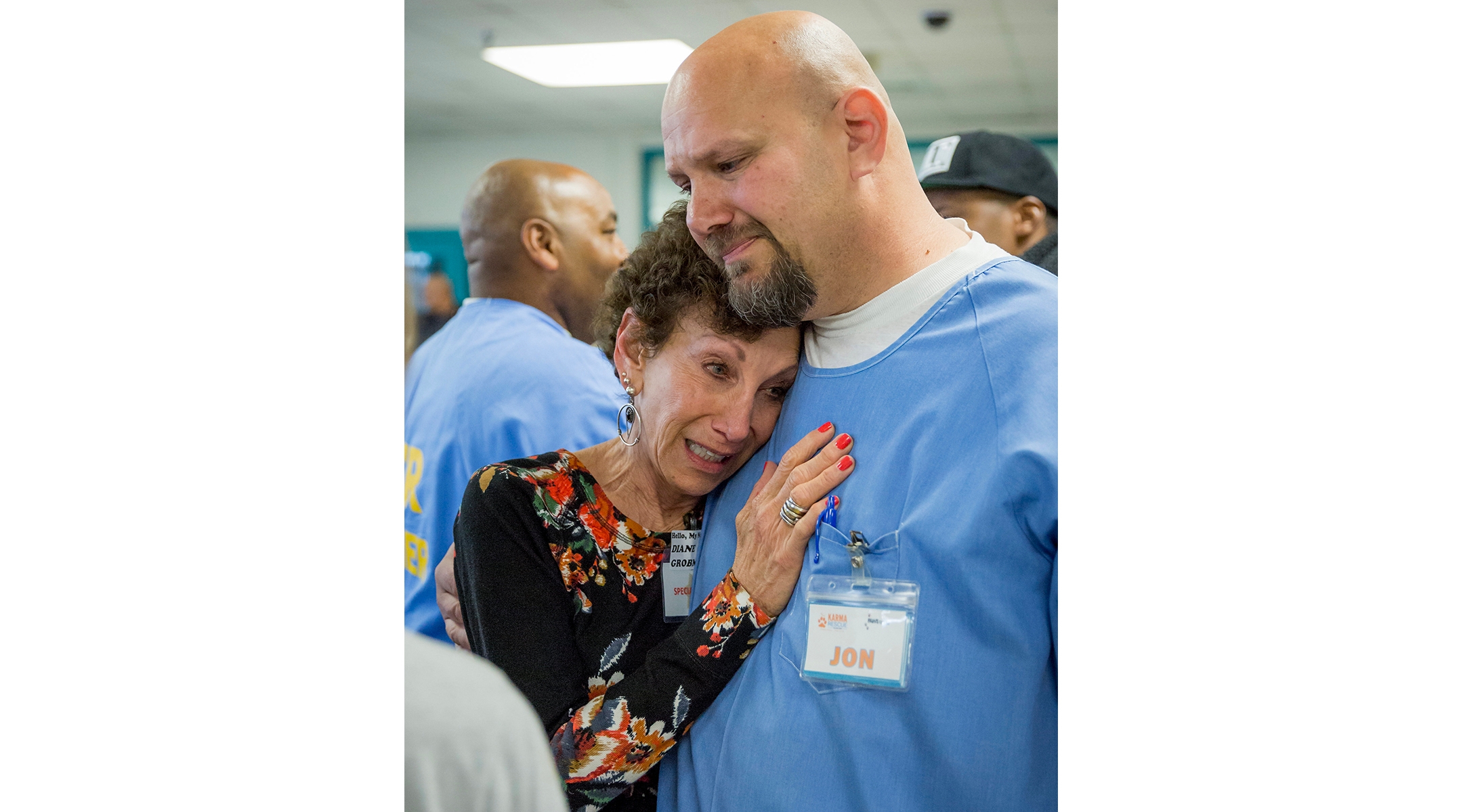 An incarcerated man hugs his mother.