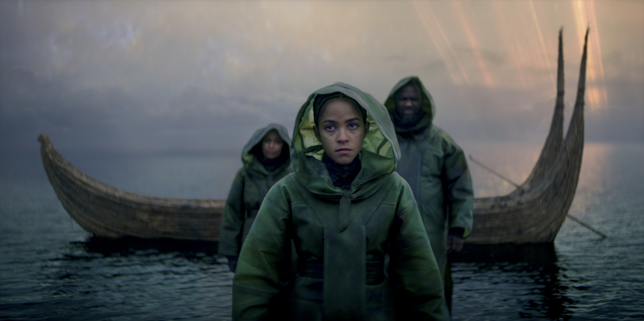 A woman in a raincoat standing in an ocean in "Foundation"