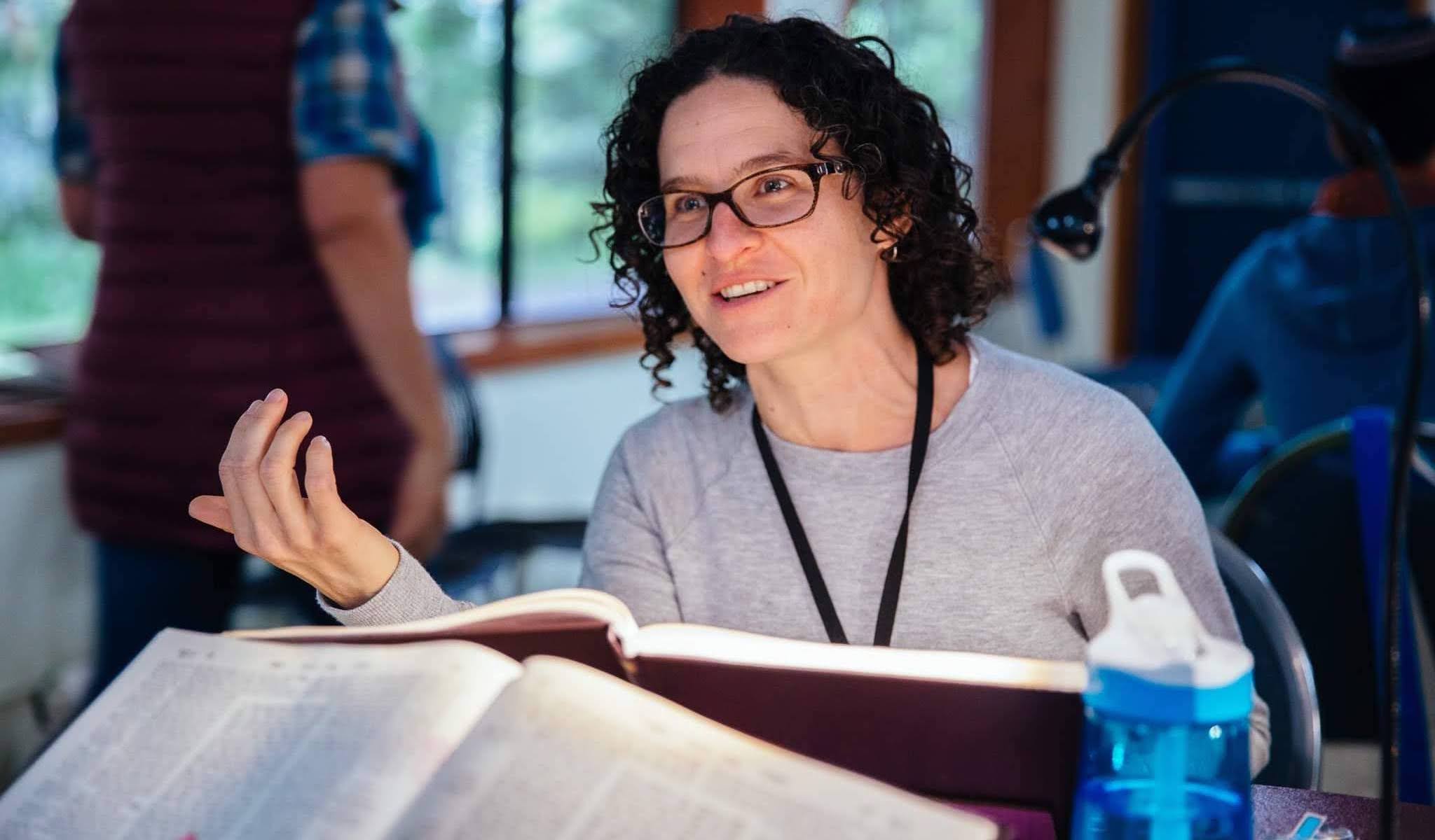 A young female rabbi pondering a holy text