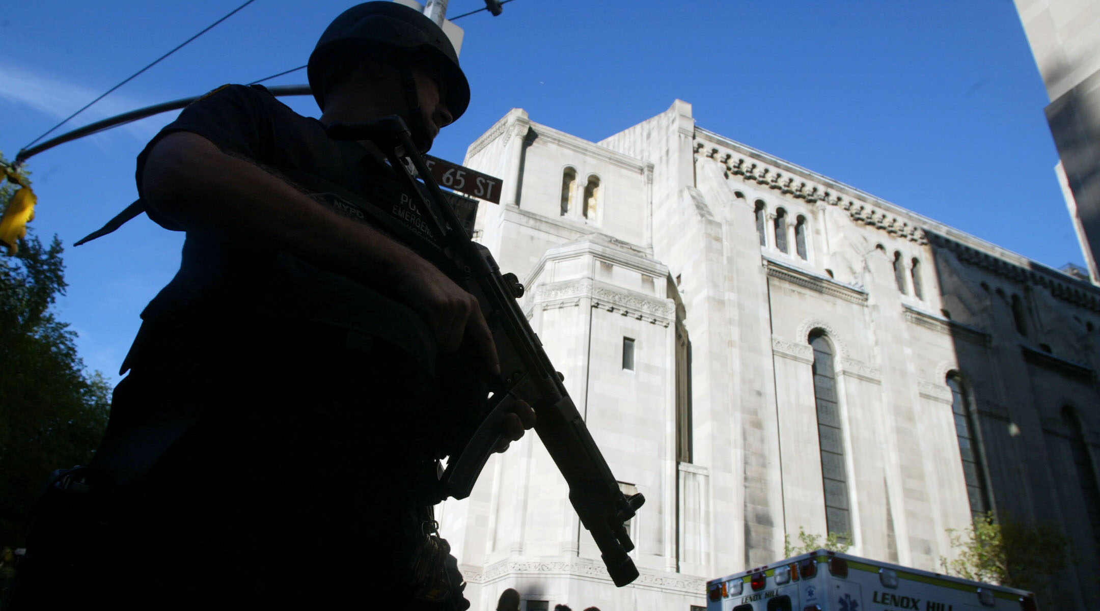 An NYPD officer stands guard outside Temple Emanu-El in New York City prior to Rosh Hashana services roughly a year after the 9/11 attacks. (Mario Tama/Getty Images)