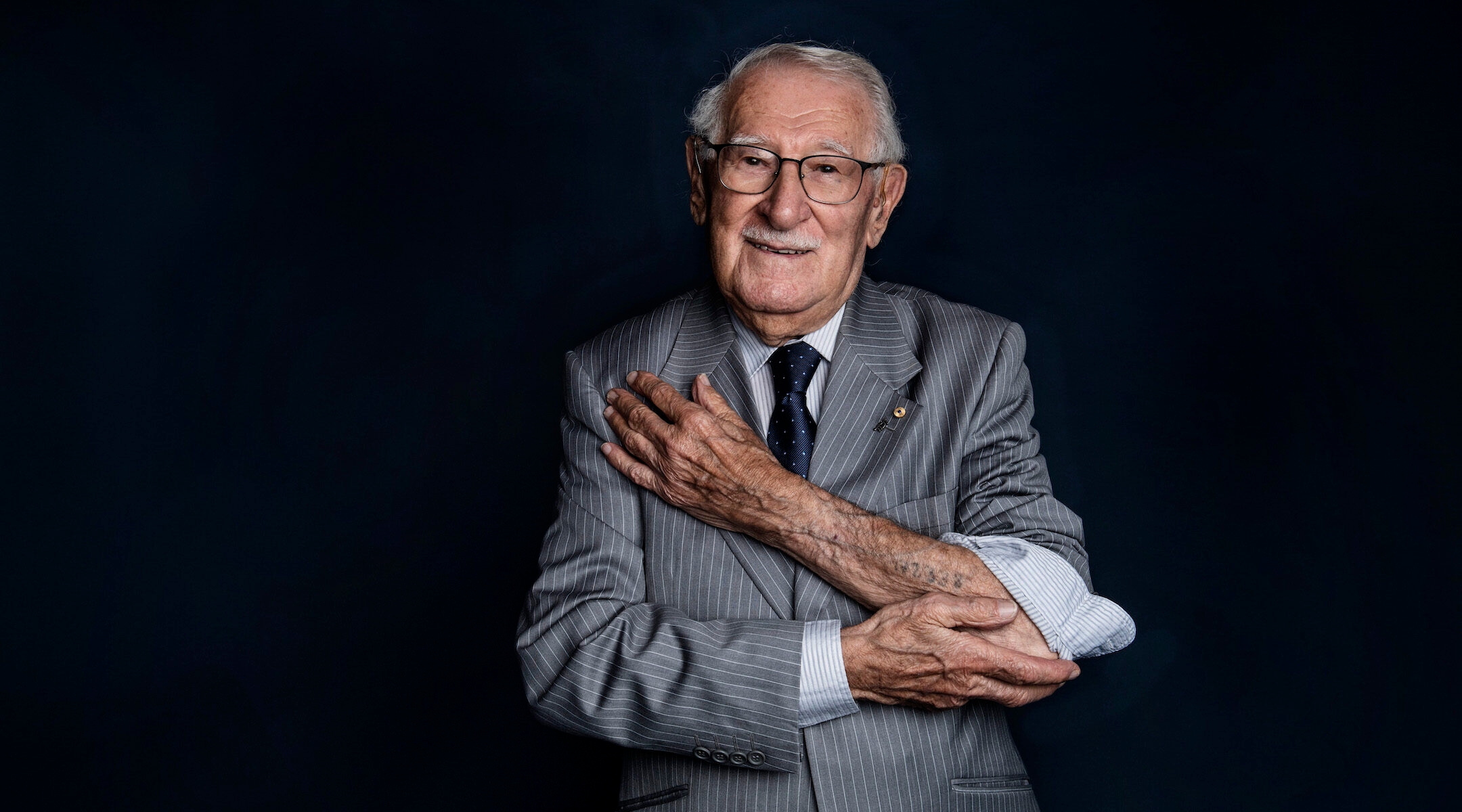 Holocaust survivor Eddie Jaku shows the concentration camp number tattoo on his left arm