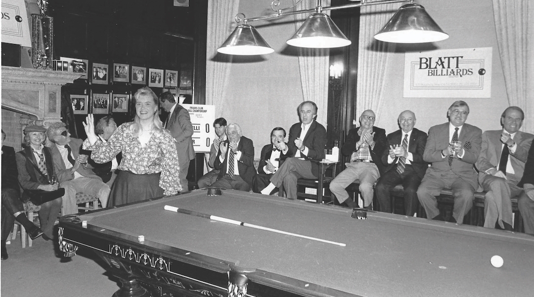 A young woman in a pool hall