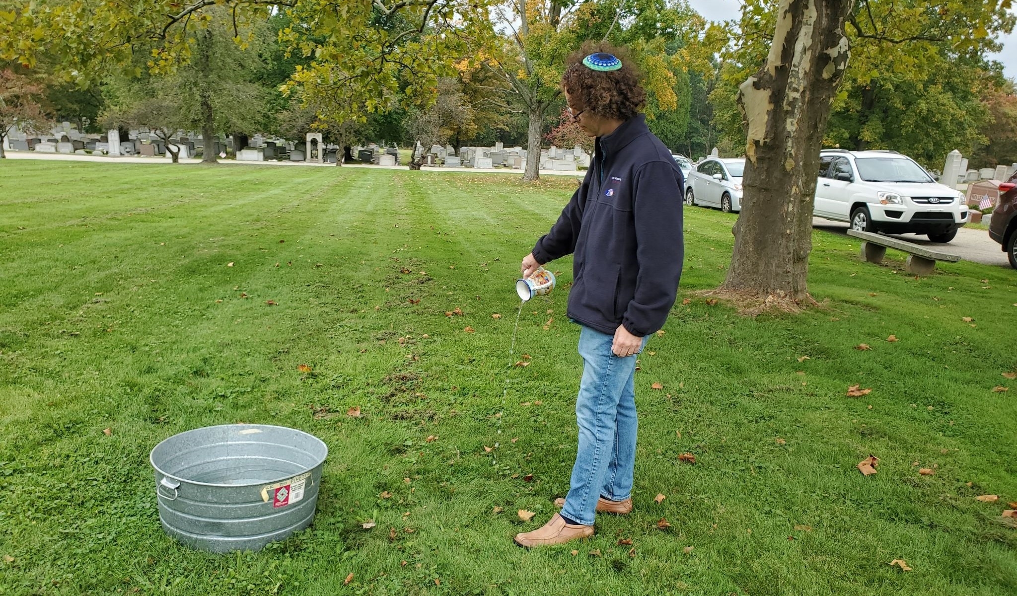 A man pouring water in a park