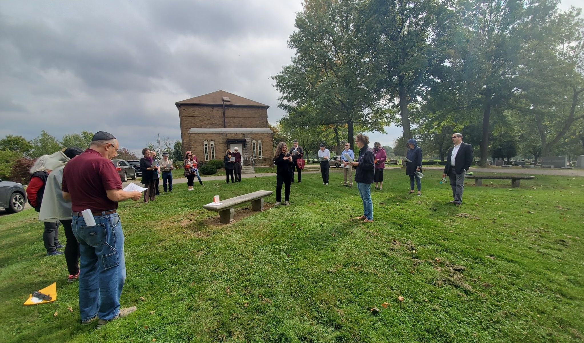 A group of worshippers performing a burial service in a cemetery