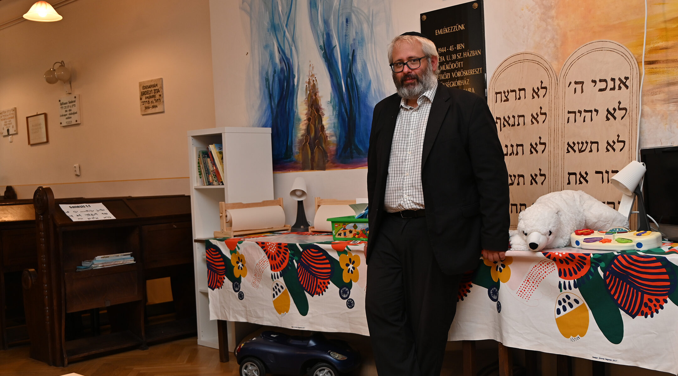 Rabbi Gabor Finali leans against the play corner at his apartment-sized synagogue in Budapest, Hungary on Aug. 29, 2021. (Cnaan Liphshiz)
