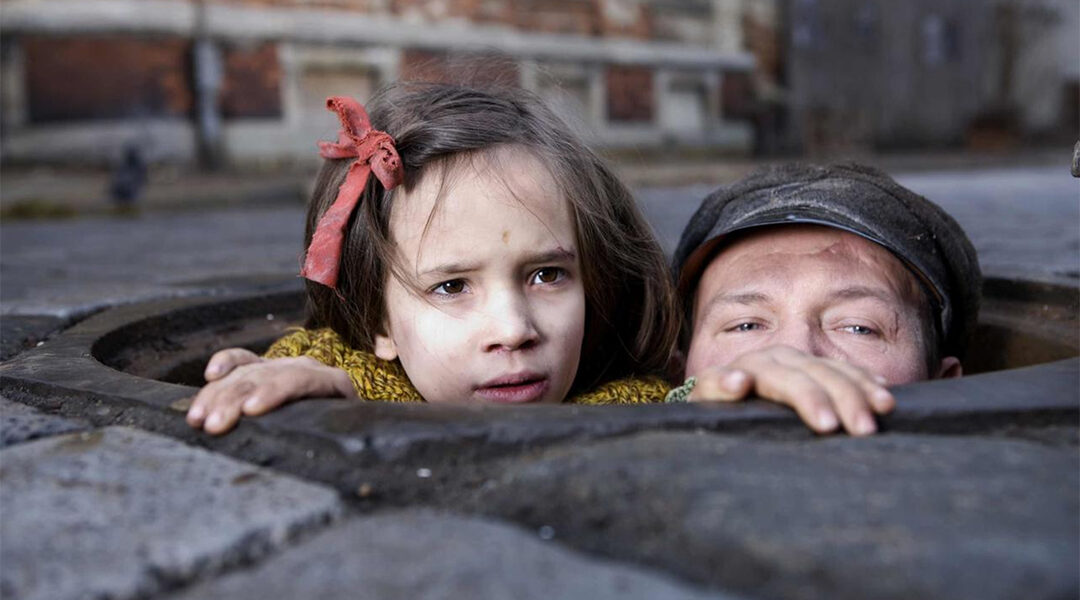 Actors Milla Bankowicz and Robert Wieckiewicz portray members of the Chiger family trying to survive the Holocaust during filming in Lviv, Ukraine in 2011. (Courtesy of Sony Pictures Classics)