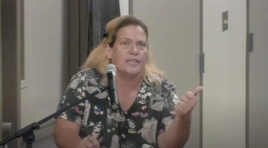 A woman at a school board meeting