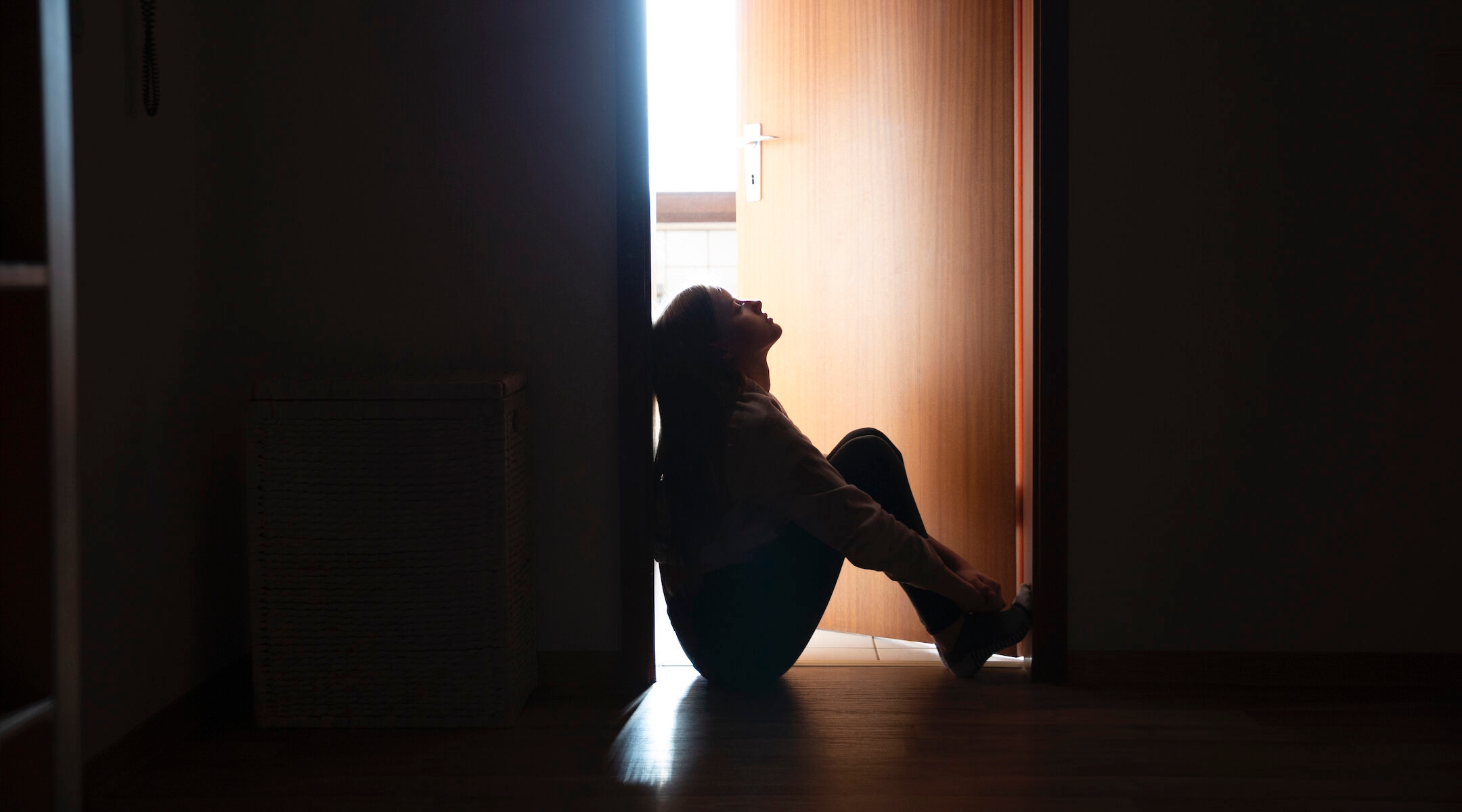 teen in shadow in doorway