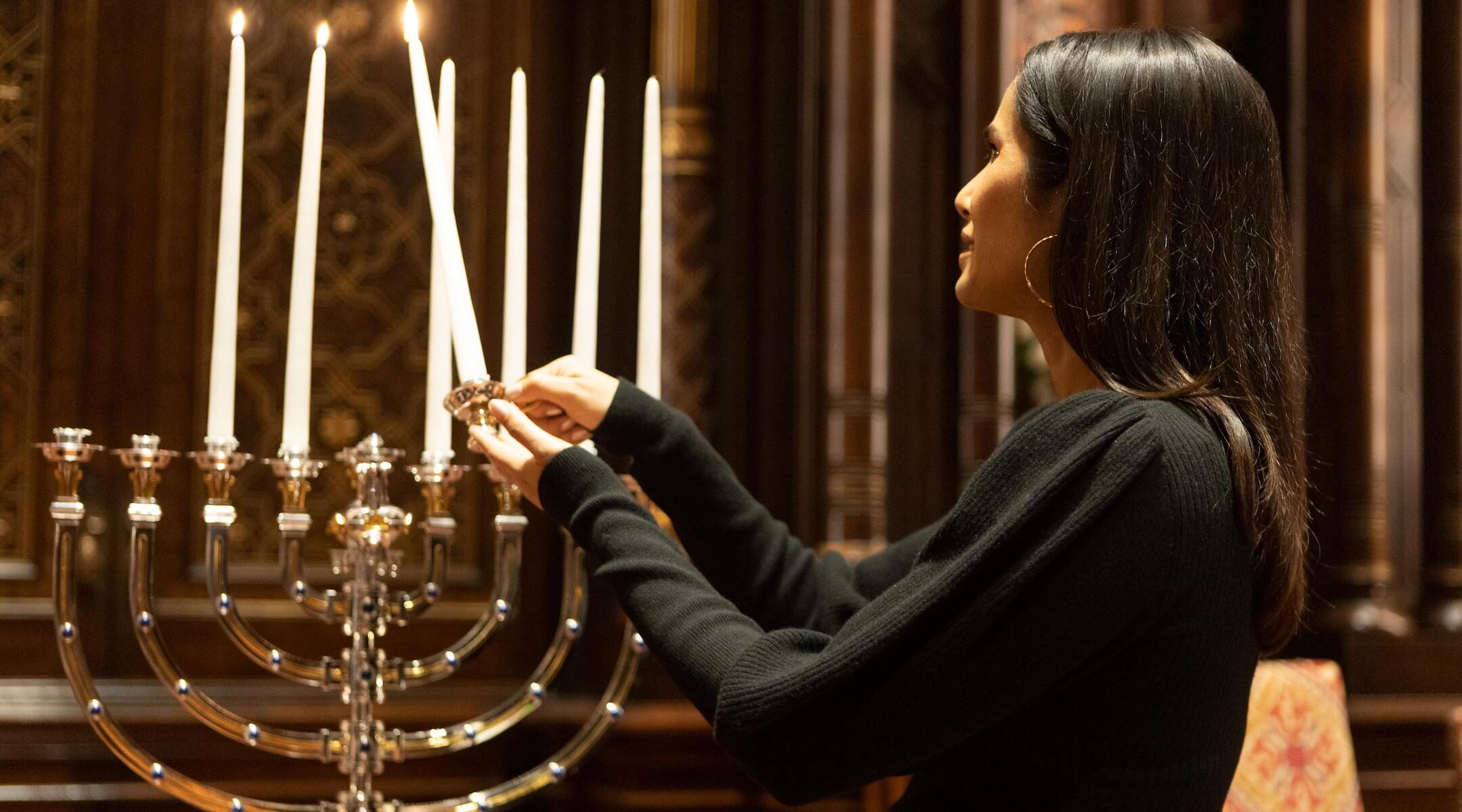 Padma Lakshmi lighting a Menorah