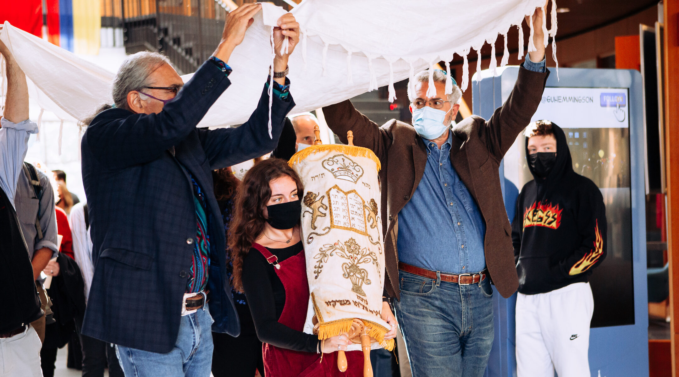 Gonzaga students and faculty lift a Torah