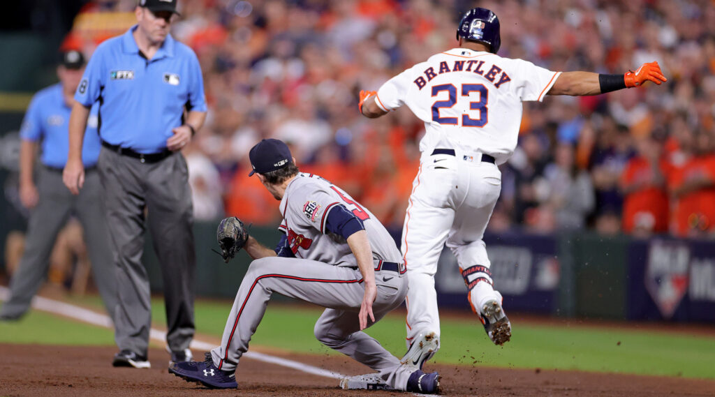 Max Fried covers first base on a ground ball hit by Astros outfielder Michael Brantley. 