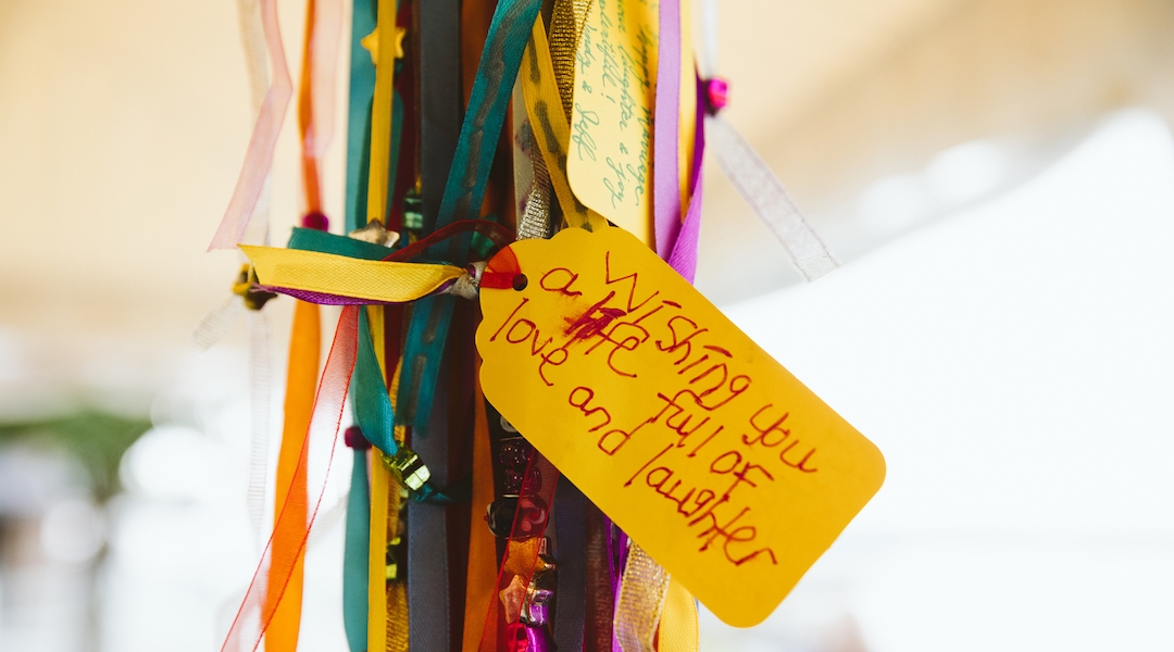 The post of a chuppah adorned with a handwritten blessing