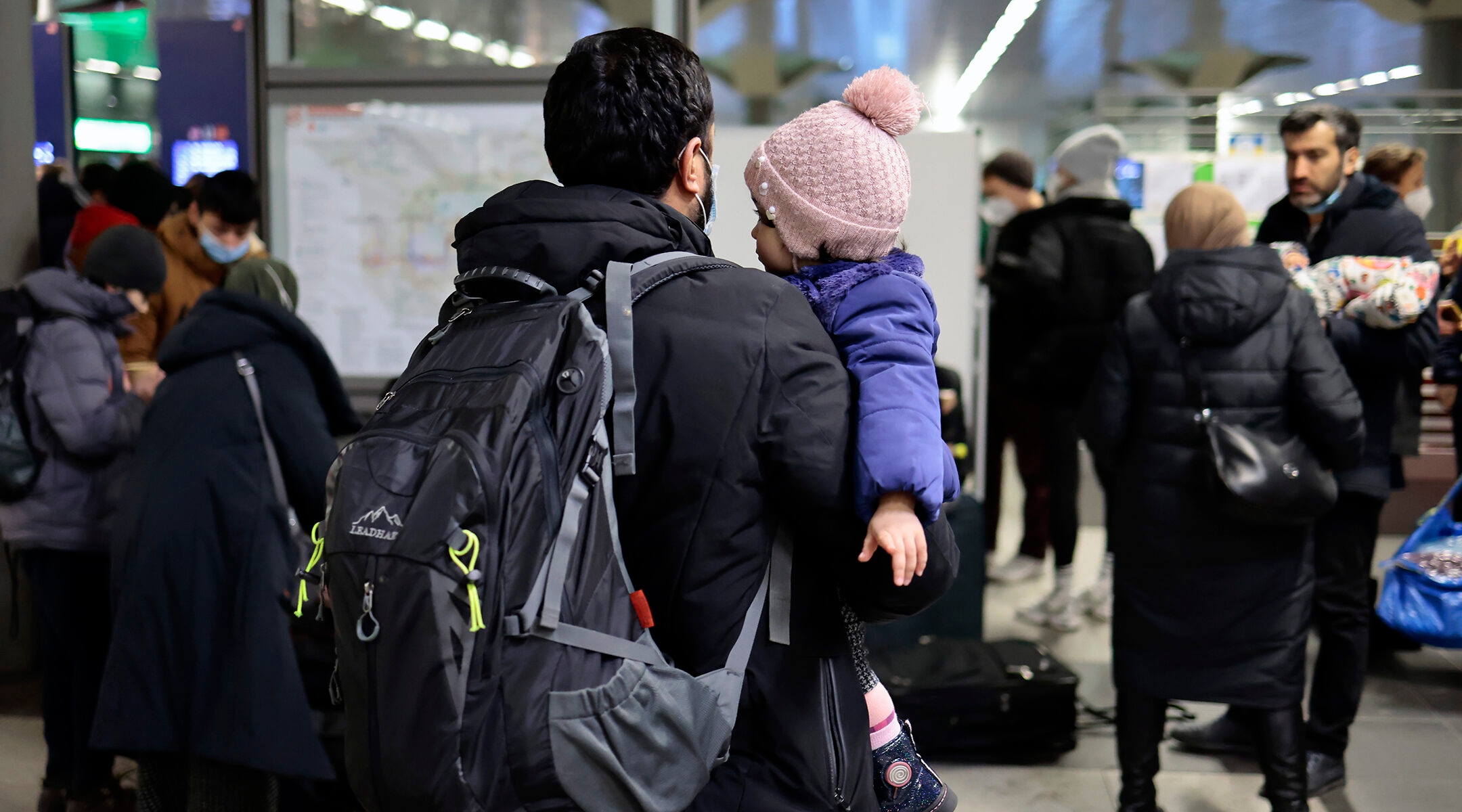 A man carries a child.