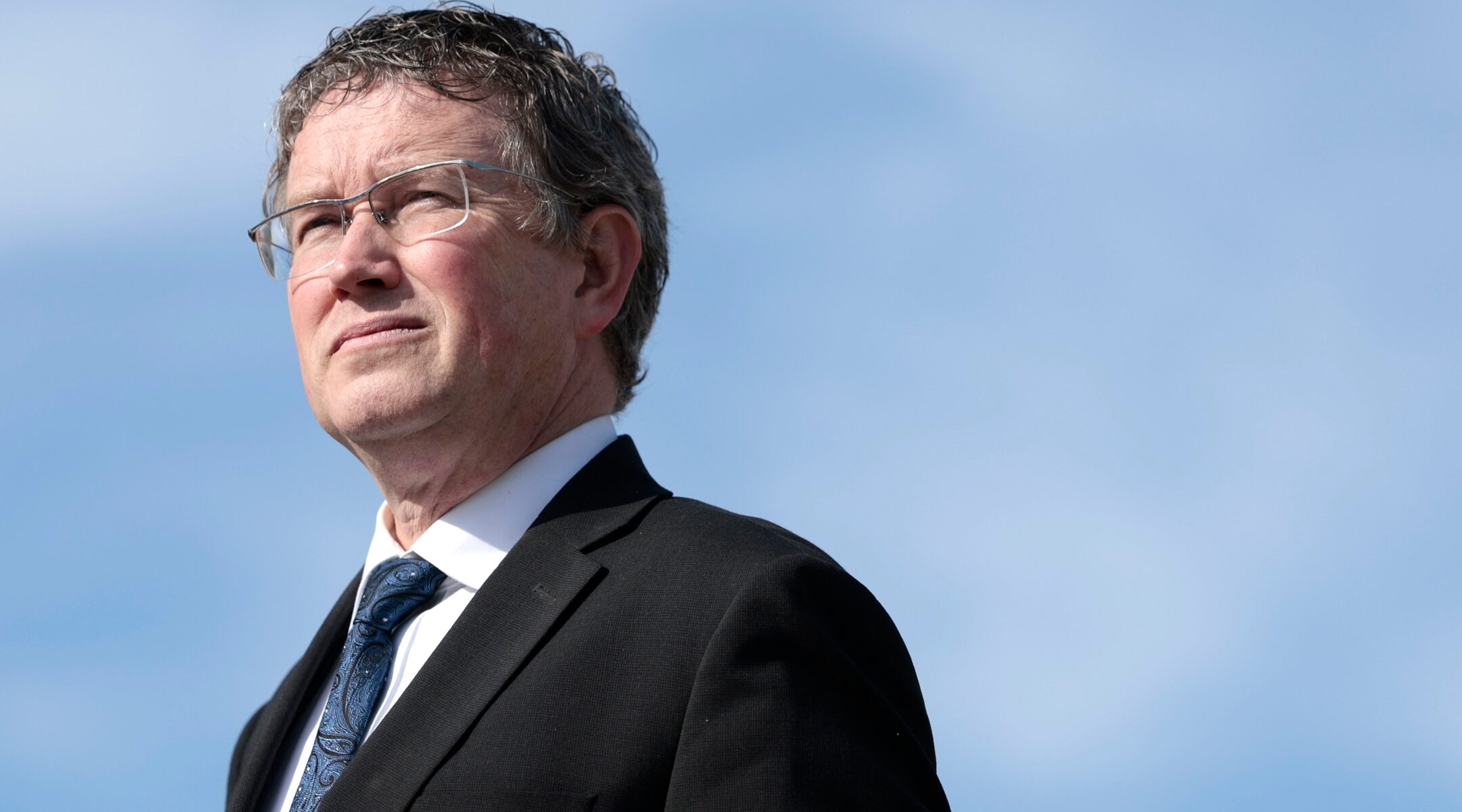 Rep. Thomas Massie listens at a press conference